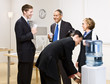 Photo: Business people drinking water at water cooler Business people drinking water at water cooler