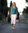 Very pretty young woman walking on the road.