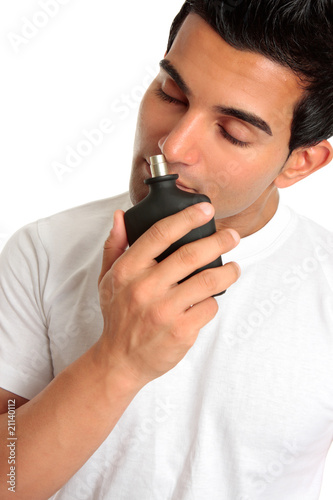 Photo: Man smelling aftershave cologne Man smelling aftershave cologne