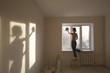 Woman cleaning windows in new apartment