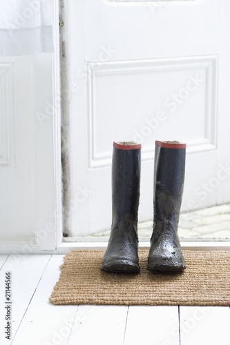 Photo: Muddy boots on door mat Muddy boots on door mat
