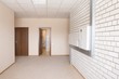 Tiled wall with fusebox in wide hallway