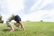 Bending over backwards, girl on grass