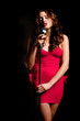 Beautiful singer singing with microphone