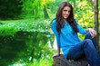 Beautiful woman outdoor near forest lake