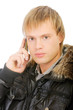 Man in winter jacket speaks on phone
