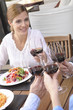 Friends clinking glasses with red wine