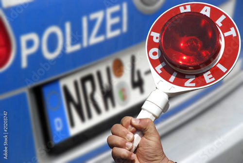 Photo: Polizeikelle am Auto mit Polizeifahrzeug Polizeikelle am Auto mit Polizeifahrzeug