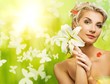 B5eautiful young woman with fresh flowers in her hair.