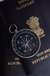 two indian passports and a magnetic compass