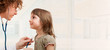 Female doctor examining little girl. Room for text
