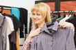 The girl chooses clothes in a boutique
