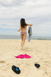 woman takes off her colthes and runs into the sea