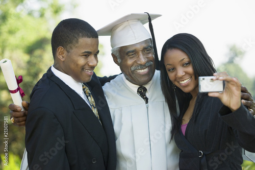 Photo: Family Taking Picture at Graduation with Cell Phone Family Taking Picture at Graduation with Cell Phone