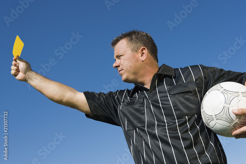 Photo: soccer referee holding yellow card portrait soccer referee holding yellow card portrait