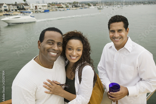 Photo: couple with friend on yacht (portrait) (elevated view) couple with friend on yacht (portrait) (elevated view)