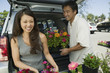 woman with husband  loading flowers into back of suv portrait