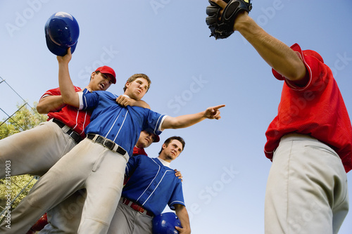 Photo: baseball players arguing on field (low angle view) baseball players arguing on field (low angle view)