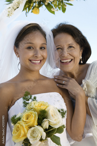 Photo: bride and mother with bouquet outdoors (portrait) bride and mother with bouquet outdoors (portrait)