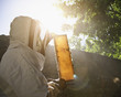 Beekeeper  holding bees and honeycomb