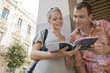 Photo: Man and woman reading guidebook Man and woman reading guidebook