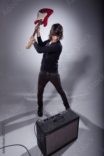 Photo: Man smashing electric guitar Man smashing electric guitar