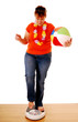 Lady weighing herself - vacation/holiday weight concept