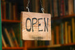 Retail and shopping image of an open sign in a book store window