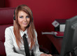 Beautiful representative smiling call center woman with headset.