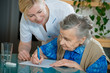 Assisting a senior woman by nurse at home. Assisting a senior woman by nurse at home.