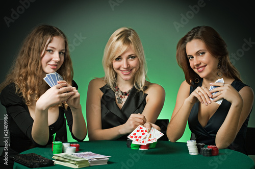 Photo: Poker players in casino with cards and chips Poker players in casino with cards and chips