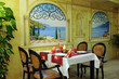 Restaurant dining area with served table ready for guests. Restaurant dining area with served table ready for guests.