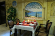 Restaurant dining area with served table ready for guests. Restaurant dining area with served table ready for guests.
