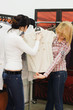 The girl chooses clothes in a boutique