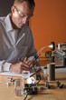 A researcher in a lab coat making notes on an experiment A researcher in a lab coat making notes on an experiment