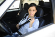 Photo: safety: female driver fastening seat belt safety: female driver fastening seat belt