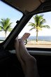 Photo: car rental: woman relaxing in her car near the beach car rental: woman relaxing in her car near the beach