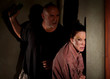 Frightened woman in hallway with menacing man Frightened woman in hallway with menacing man