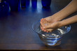 Two hands in a glass bowl of water Two hands in a glass bowl of water