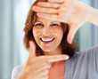 Happy young female making a frame with her hand