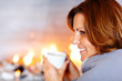 Photo: Pretty young woman enoying coffee at home Pretty young woman enoying coffee at home