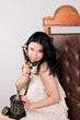 Photo: Cheerful woman speaks by ancient phone Cheerful woman speaks by ancient phone