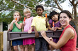 Photo: Preschool children playing on playground with teacher Preschool children playing on playground with teacher