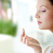 Photo: Woman applying moisturizer cream on face Woman applying moisturizer cream on face