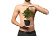chest of young man presenting a young tree