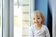 girl sits at  window