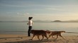 Young girl running with two dogs