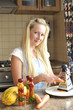 Young housewife grating vegetables