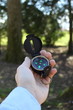 Businessman holding a compass vertical