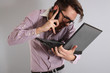 a young man with a phone and laptop